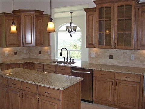 Slab granite, maple cabinets & travertine floors