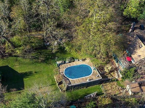 Arial view, rear yard looking West, Pool w/IPE deck;
South of House at right w/upper veranda -(red umbrella)