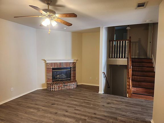 living area with gas fireplace, stairs to upstairs bedrooms and stairs to master bedroom and laundry room