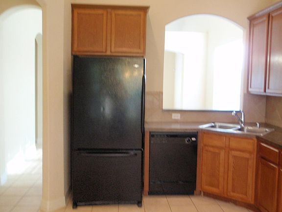 Kitchen with refrigerator and pass thru bar
