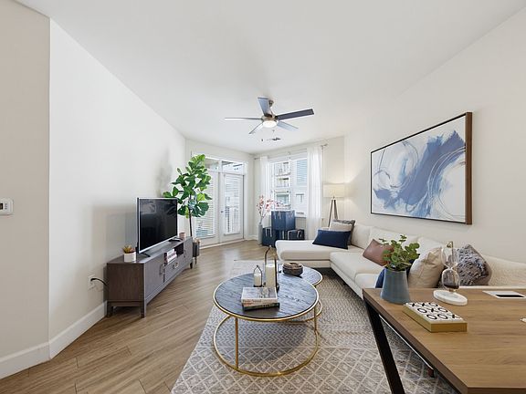 Daylight comes in from the balcony side and reaches across the floor.