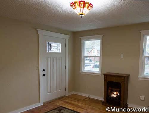 Cozy gas fireplace and stain glass light fixture
