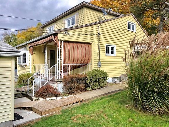 Side view of the house has garage access and side entrance to the property as well.