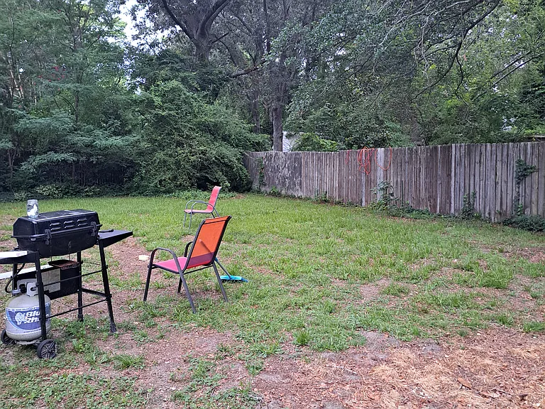 Back yard, fenced in with six foot high wooden fencing