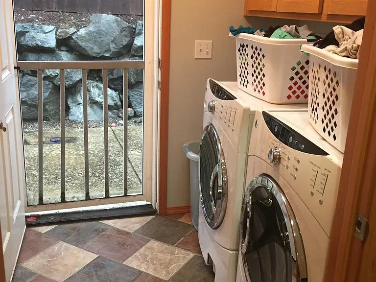 Laundry room includes a counter and sink as well as tons of