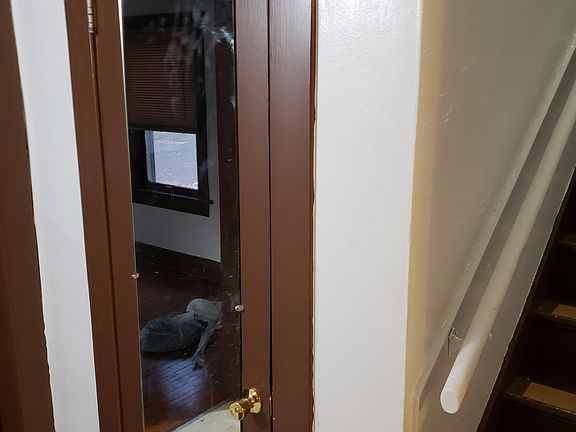 FOYER WITH 1/2 BATH DOOR AND STAIRS TO 2ND FLOOR