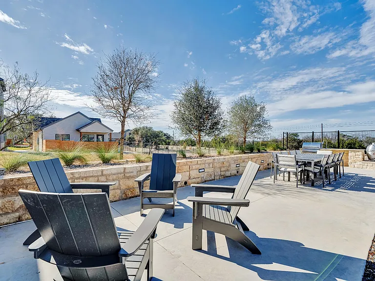 A patio with chairs and a table is set up outside.