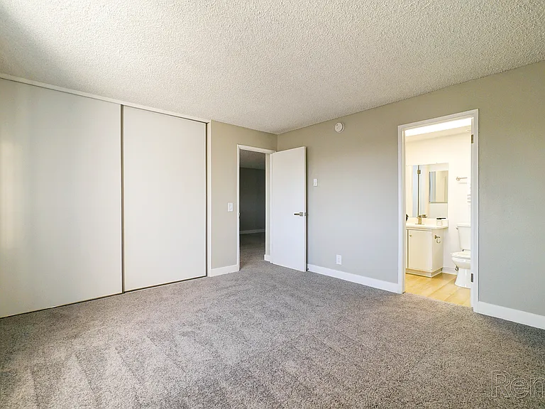 Experience the serenity of this spacious bedroom, featuring new carpeting and abundant natural light.
