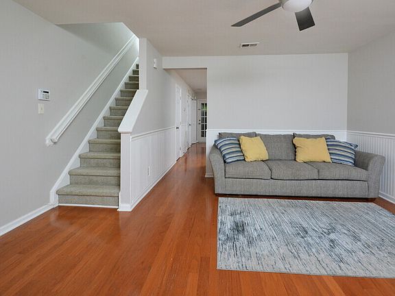 Living room/stairs (note unit comes unfurnished)