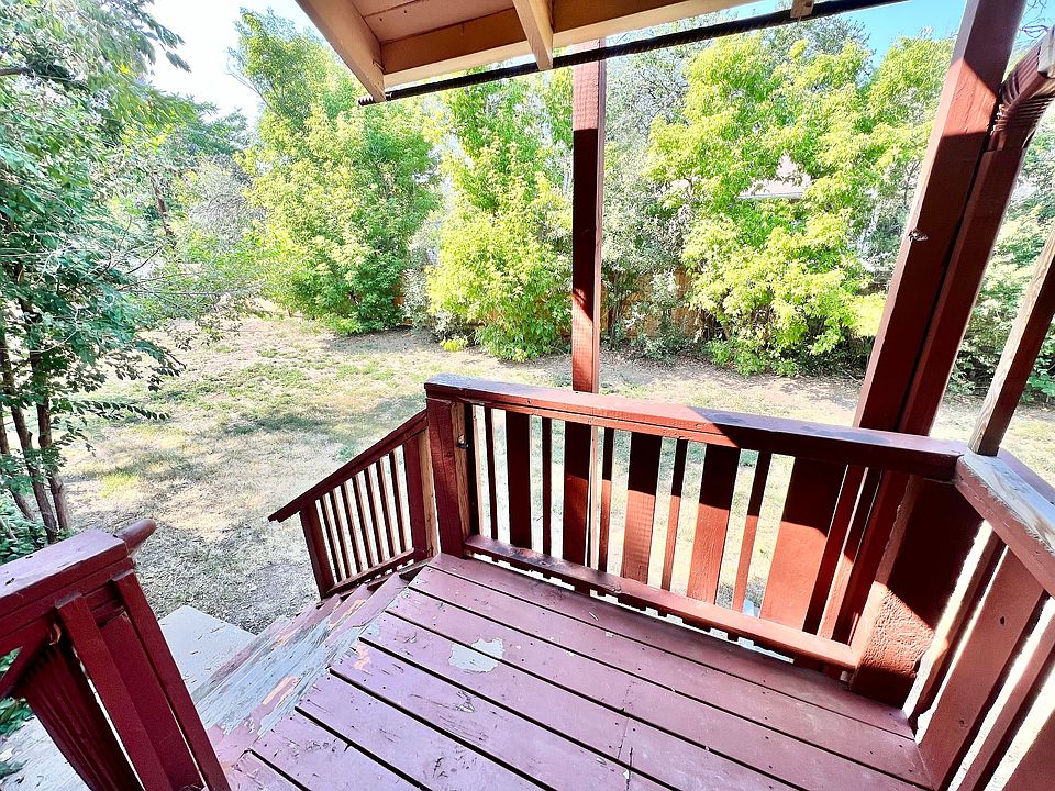 Step into tranquility on this charming wooden balcony with a garden view.