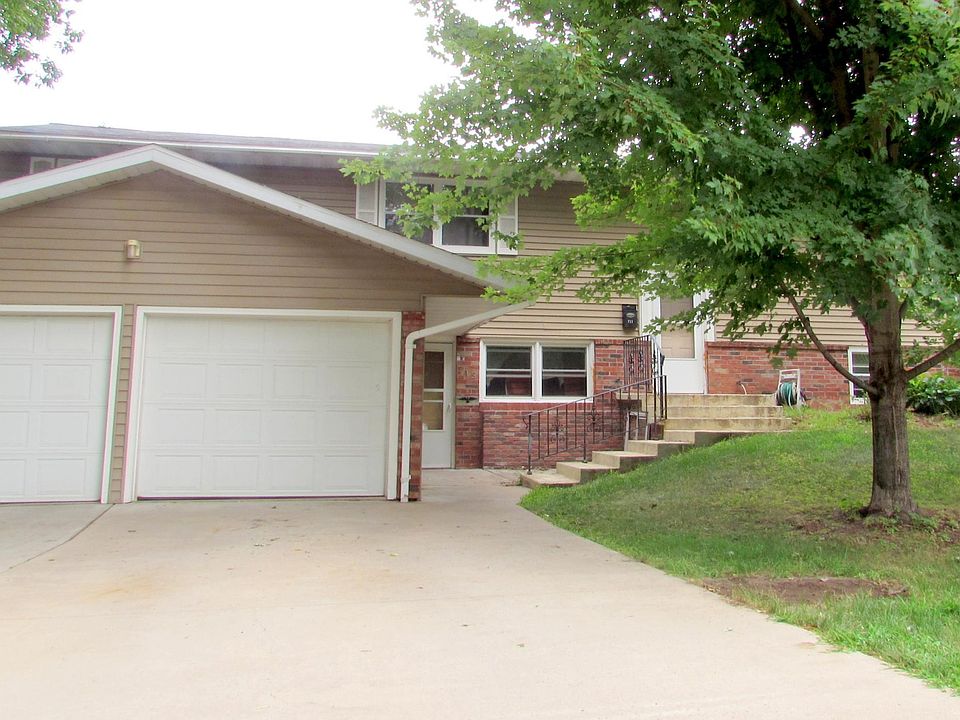 Cement stairs shown lead to upper Unit currently listed for rent: 711 Witter St. 54494. Garage and driveway are shared ground level tenants.