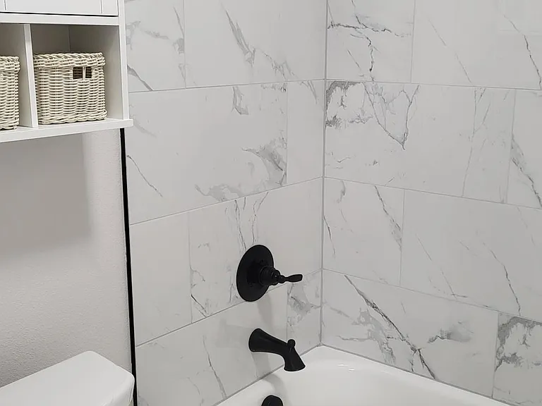 Updated bathroom with a tub.