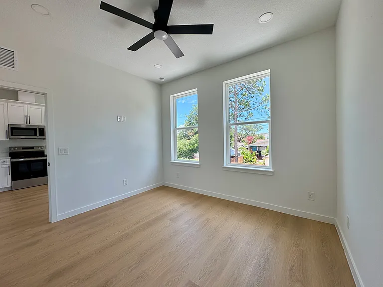 Spacious bedroom with large windows.