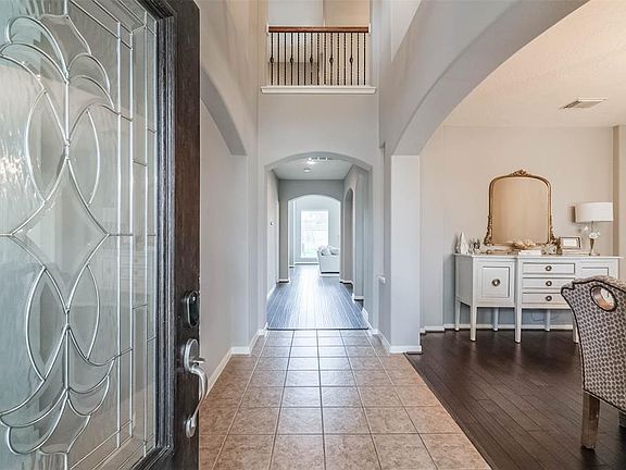Spacious foyer features high ceilings. The 2- car garage is located to the left, formal dining room is located to the right.