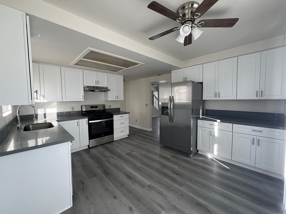 Completely renovated kitchen with stainless steel appliances, fridge with water dispenser, ample cabinets with area for dining table