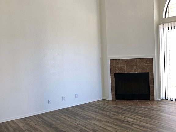 Living Room with Wood Burning Fireplace and High Vaulted Cei