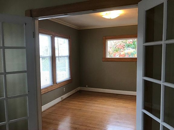 Light filled Dining room/home office as seen from Living room. Faces east and south. Operable double hung insulated windows, large closet, top nailed original oak floors