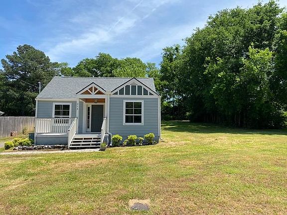 Front view of home. Driveway is on right side. Lots of open space!