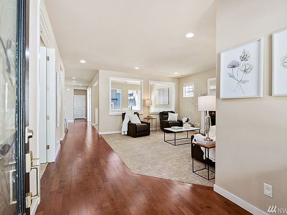Flowing floorplan with beautiful hardwood floors & sunlit rooms