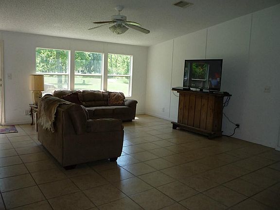  Living Room with Tile Floors, Ceiling Fan, and Gorgeous View of Front Yard. Notice The A/C Vents are in Ceiling, not in Floor