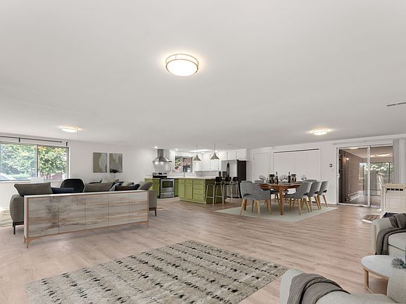 Fully open floor plan, seamlessly connecting the living room, dining room, kitchen with large island, and foyer. VIRTUALLY STAGED