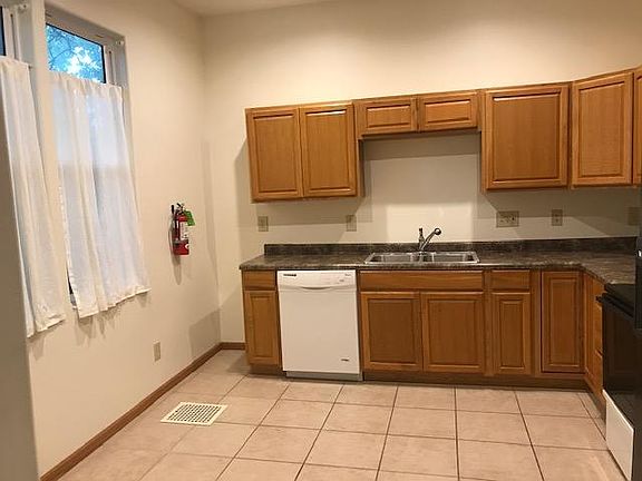 Large kitchen with lots of space and a dishwasher.