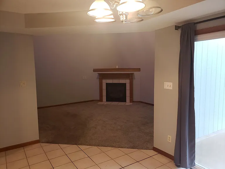 Living room view of gas fireplace from dining room vantage point