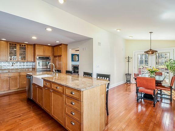 Sun-filled kitchen with a wall of windows overlooking 2 private acres.