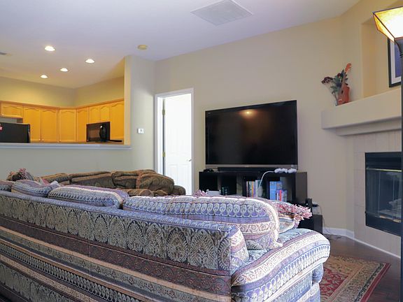 Living room facing kitchen and entrance to master bedroom