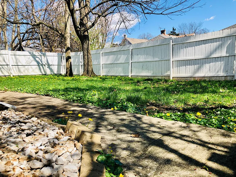 Backyard is fully enclosed with six-foot-high white privacy fence & two gates