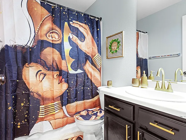 Spa-like bathroom with a modern vanity and a touch of artistic flair. Perfect for unwinding after a long day.