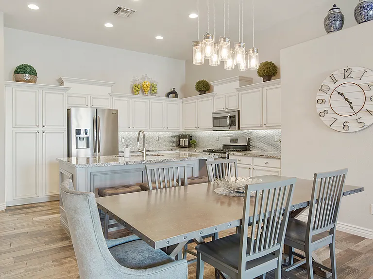 Dining room with 6 chairs at the dining table and 3 bar stools