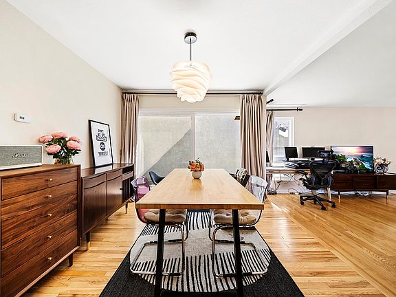 The formal dining room is connected to the side yard by the sliding doors.