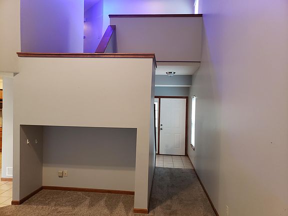 Living room view, looking at front door and entertainment center nook