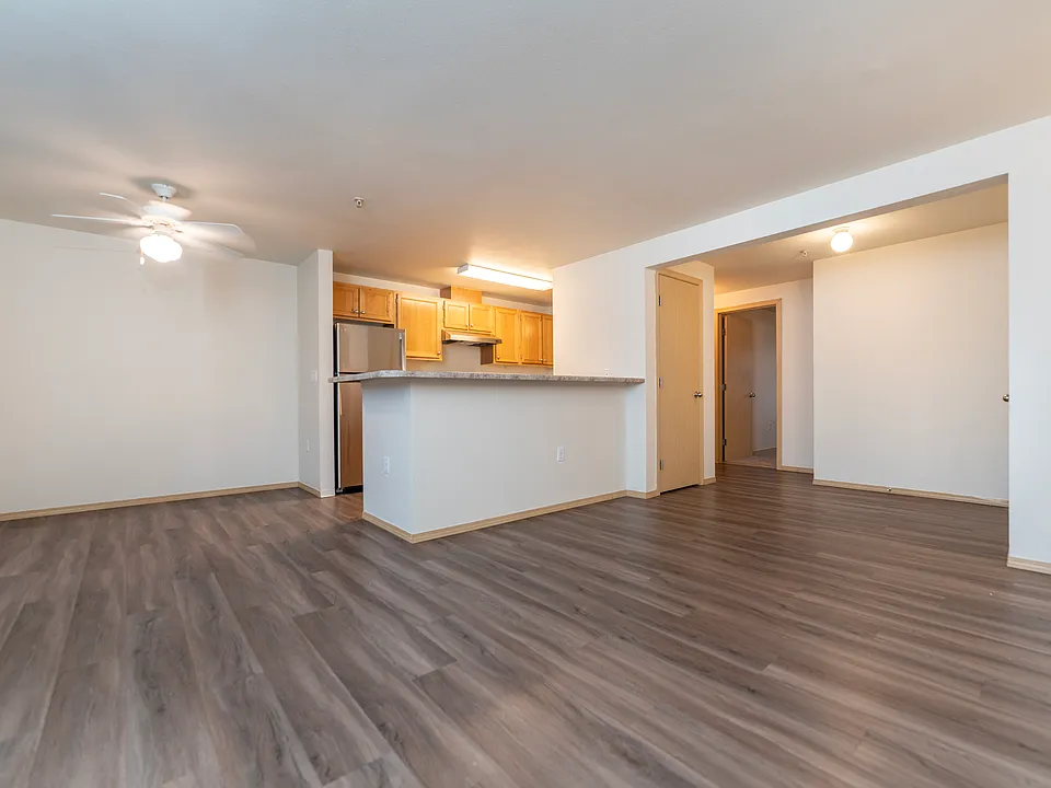Spacious open-concept layout with a modern kitchen and wood-style flooring.