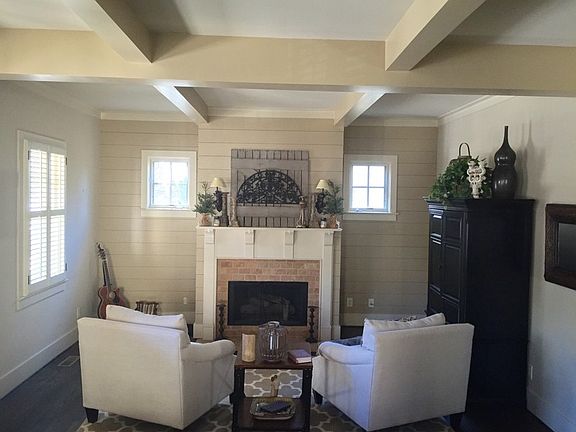 Left side of great room : Wood accent wall, painted beams, 5" ebony river bottom pine hardwood floor