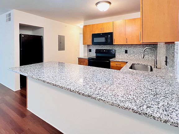 Granite Countertops with Finished Wood Cabinets.
