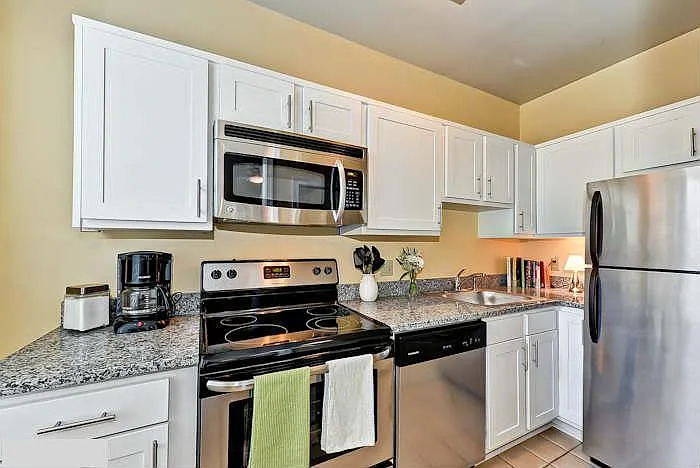 Modern kitchen with updated stainless steel appliances, including microwave and diswasher