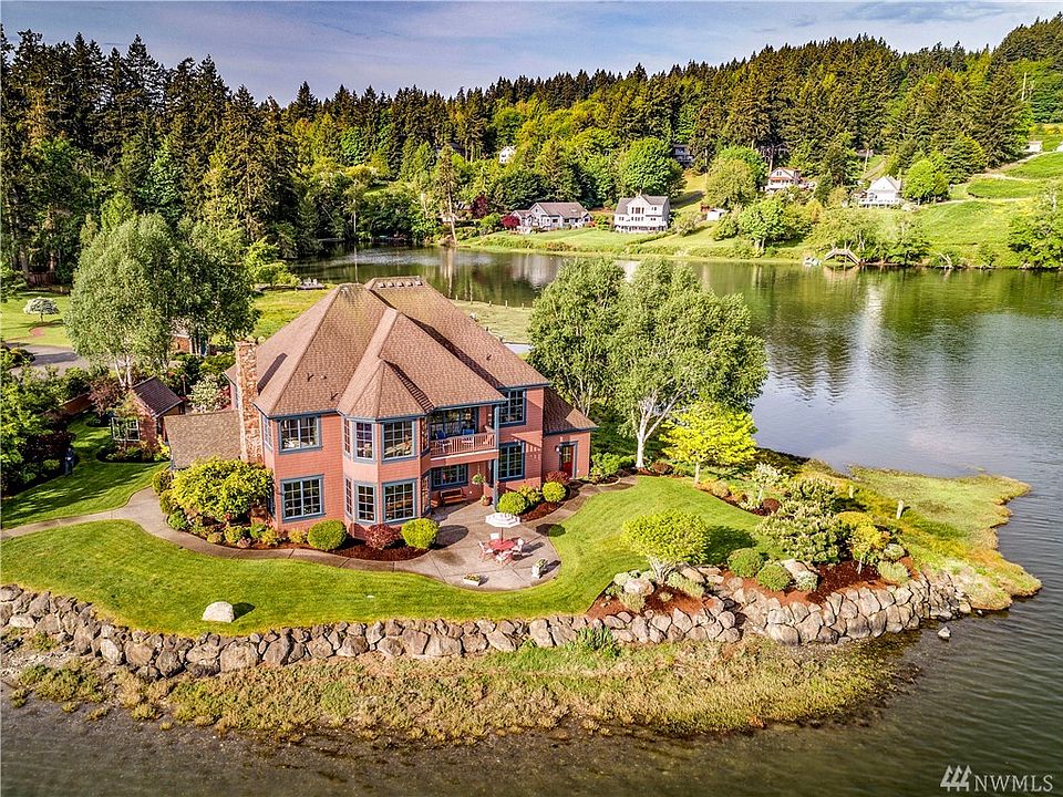 Water, water everywhere! Stunning home at the tip of Scandia Point with 750 feet + (per survey) of Liberty bay waterfront.