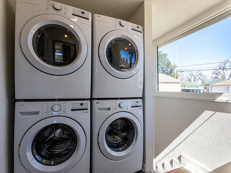 Your own full size stacked LG washer/dryer (on the left) inside the covered back porch.