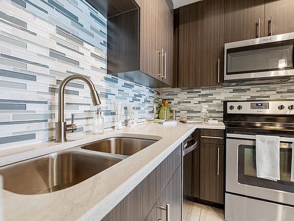 Kitchen and kitchen island within open concept apartment in Boca Raton.