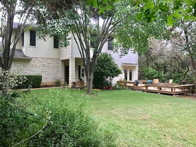 Soft Zoysia grass with sprinkler system. Nestled behind an open gate, too large to fence, surrounded by trees. Custom built for owner