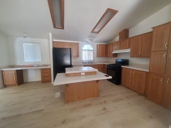 Kitchen included dishwasher, island counter, and desk area.