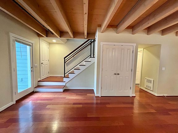 Patio door, large coat closet, pantry, and powder room. Stairs down to private basement garage just to the left.