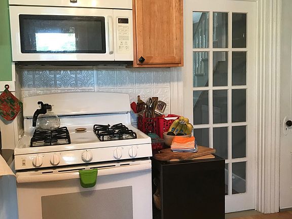 More of kitchen. Glass door leads to front hallway.