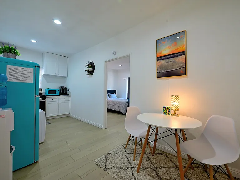 Fully furnished living room with upgraded kitchen, appliances, and laundry machines