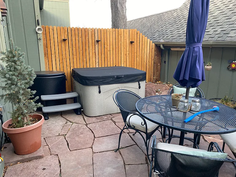 Outdoor patio space with jacuzzi and cold plunge.