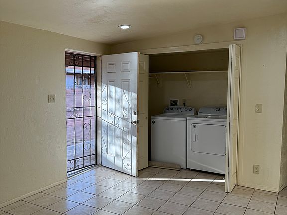 large living area. Laundry area. View to outside front yard.