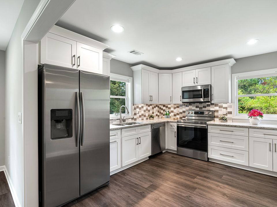 Beautiful, brand new kitchen with SS appliances, granite counters, and white shaker cabinets.