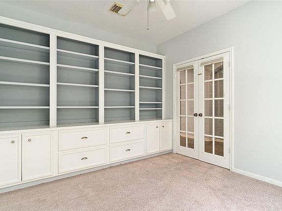This private office/study is to the left as you enter the home, it features custom build in bookcases and file drawers, and brand new carpeting...I'm sure you can get a lot of work done in this quiet space